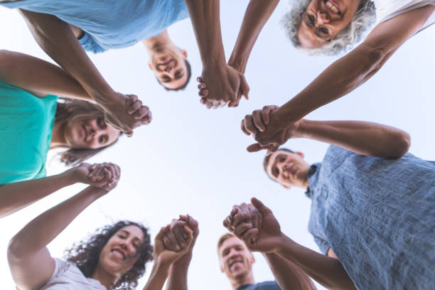 istock Low angle shot of multiethnic group holding hands 1132058682