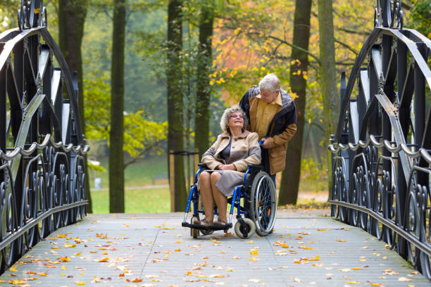 old couple in the park stock photo
