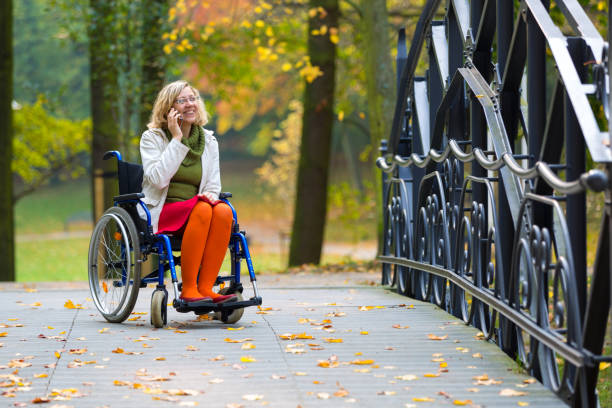 happy woman on wheelchair talking on the phone stock photo
