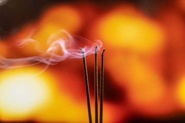 istock Burning Incense Sticks with smoke, joss sticks burning at a vintage Buddhist temple. Focus on incense stick and smoke. 1132059004