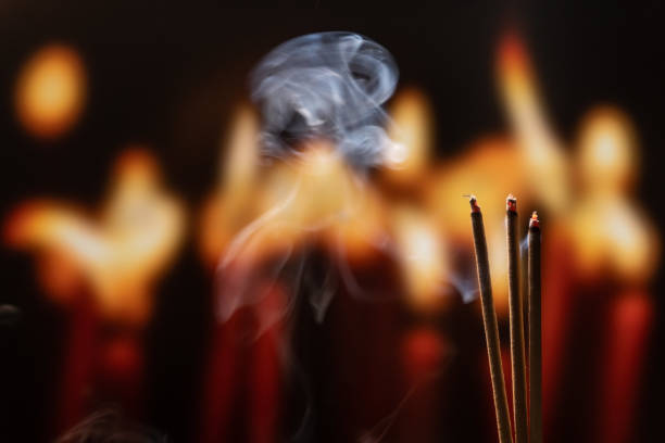 istock Burning Incense Sticks with smoke, joss sticks burning at a vintage Buddhist temple. Focus on incense stick and smoke. 1132059455