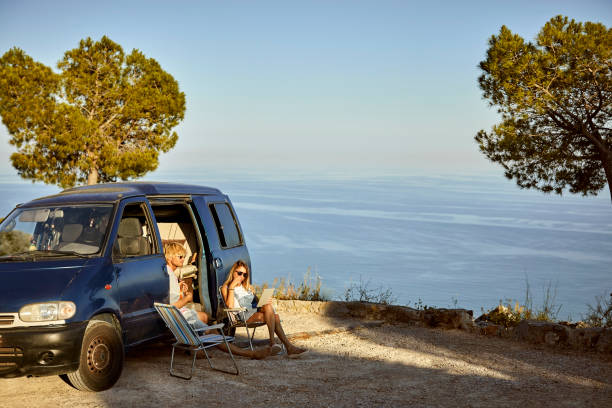 istock Couple spending leisure time on cliff against sea 1132059913