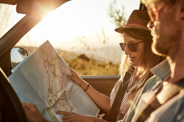 istock Woman showing map to man driving van 1132059934