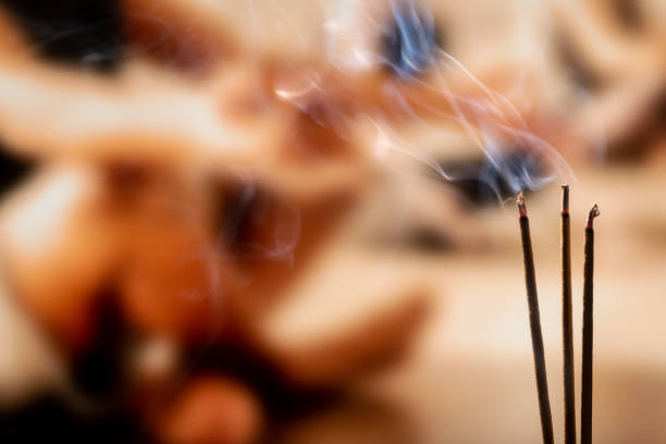 istock Burning Incense Sticks with smoke, joss sticks burning at a vintage Buddhist temple. Focus on incense stick and smoke. 1132060697