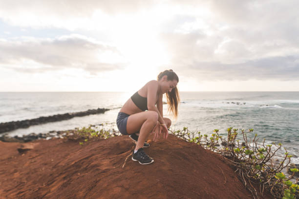 istock Female jogger taking a break from running along the Hawaii coastline 1132061111