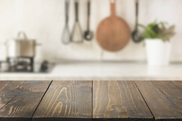 istock Modern kitchen with wooden tabletop, space for you and display products. 1132061248