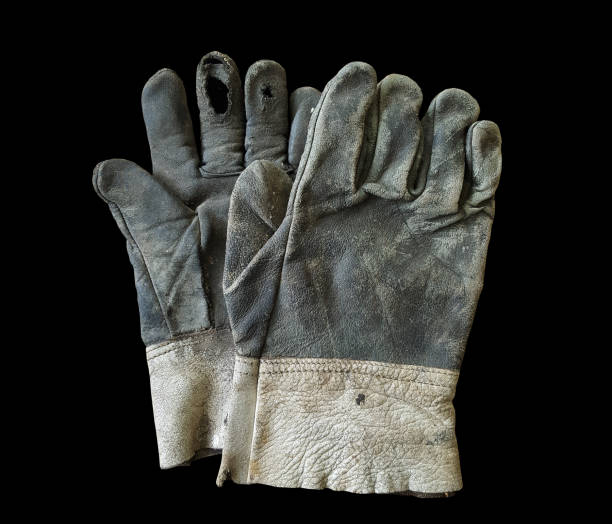istock old leather gloves are lack on back background 1132062072