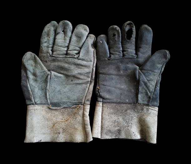 istock old leather gloves are lack on back background 1132062114