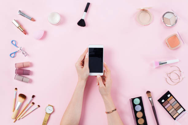istock Make up products with woman holding smart phone 1132064113