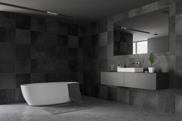 istock Black tile bathroom corner, tub and sink 1132066306