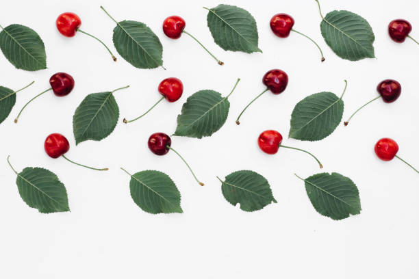 istock Fresh red cherry and leaf pattern on white background. Concept of healthy eating. Flat lay, top view, copy space 1132067020