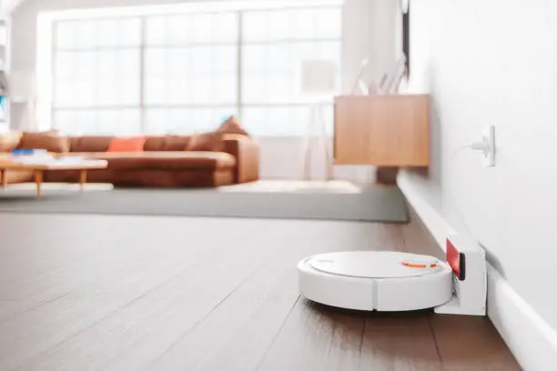Close-up shot of a robot vacuum cleaner in a modern living room.