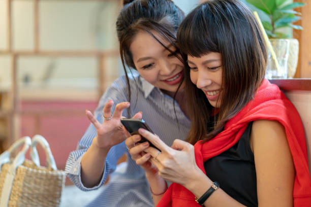 istock Two young women checking a smartphone 1132067042