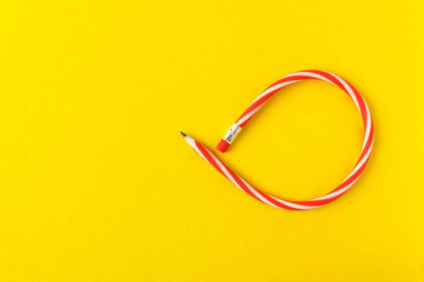 istock Flexible pencil . Isolated on yellow background. Bending pencil. 1132067140