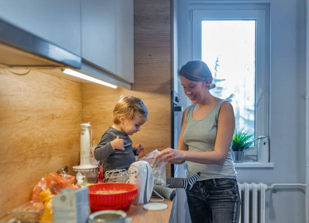 istock Playful mother and her baby baking together 1132070894