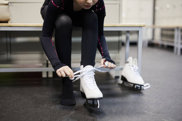 istock Girl Tying Ice Skates 1132070993