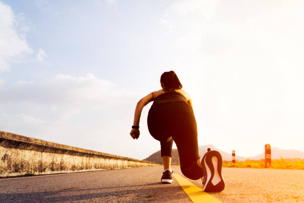 istock Ready go. running woman on start position and going to run on long road 1132075710