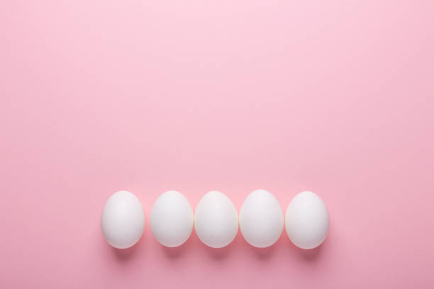 istock White eggs on pink background. Symbol Happy Easter Flat lay 1132075743