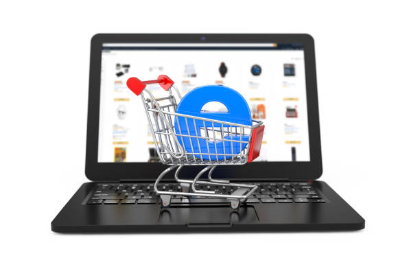 istock E-Commerce Concept. Shopping Cart Trolley with Blue Letter E as Electronic Commerce over Modern Laptop. 3d Rendering 1132075998