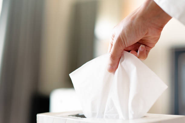 istock women hand picking napkin/tissue paper from the tissue box 1132077138