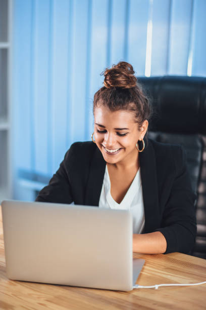 istock A young girl dressed in business clothes is working on a laptop. 1132077458