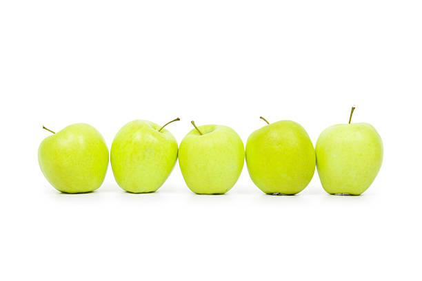 istock Green and yellow apples on a white baclground 113207866