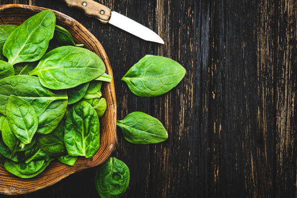 istock Spinach in the wooden bowl 1132079259
