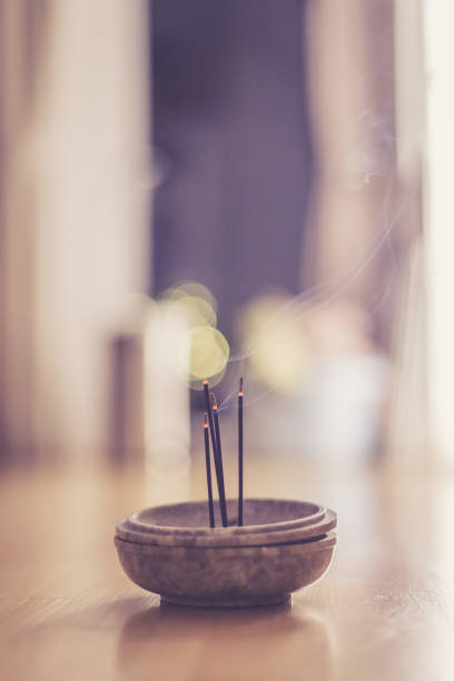 istock Smoking and smelling joss sticks at home, feng shui; Copy space 1132079966