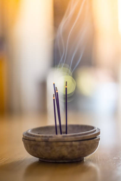istock Smoking and smelling joss sticks at home, feng shui; Copy space 1132079978