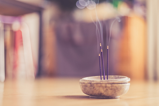 Joss sticks in smoking bowl are smoking and smelling, home, feng shui; Copy space;