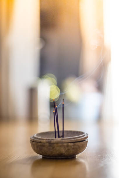 istock Smoking and smelling joss sticks at home, feng shui; Copy space 1132079983