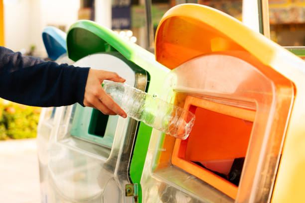 women hand throwing away the garbage to the bin/trash, sorting waste/garbage before drop to the bin stock photo