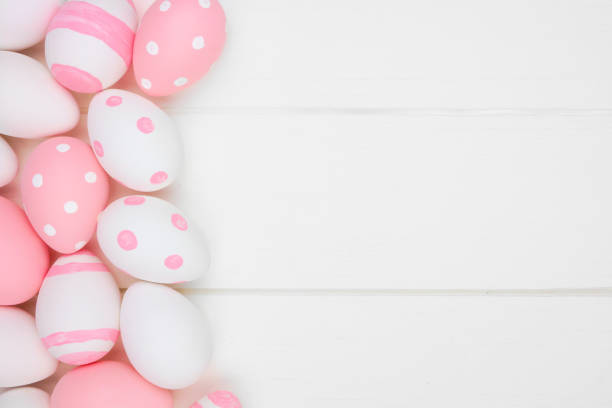 istock Pink and white Easter Egg side border against a white wood background 1132081911