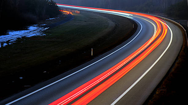 istock traffic on the highway at night 1132083097