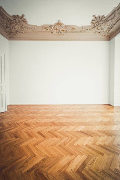 istock parquet floor , white walls and stucco ceiling in empty room after renovation - 1132083476