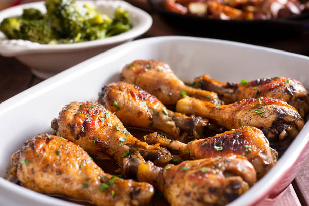 Marinated Chicken Legs Marinated Chicken Legs in a Baking Dish with Steamed Broccoli and Roasted Potatoes chicken meat stock pictures, royalty-free photos & images