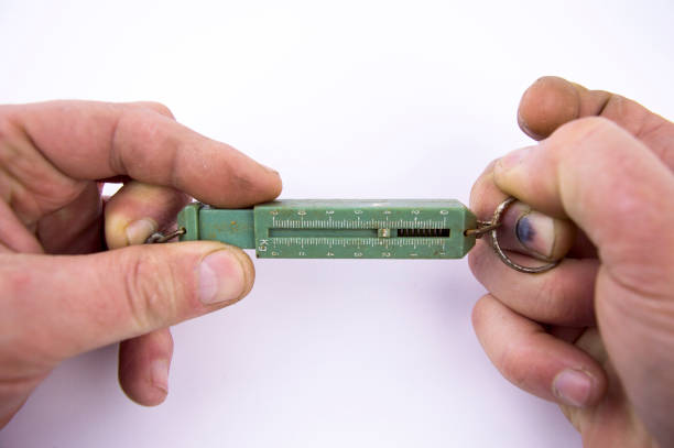 istock hand spring scales old in the hands of a man 1132088453