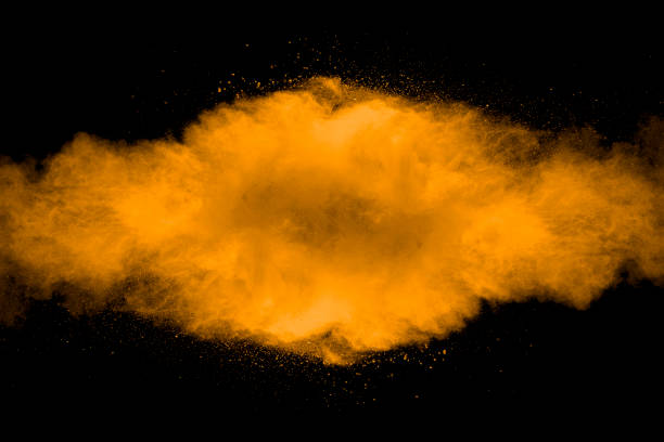 Abstract art orange powder on black background.