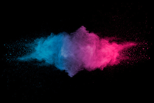Stopping the movement of multicolored dust on black background.