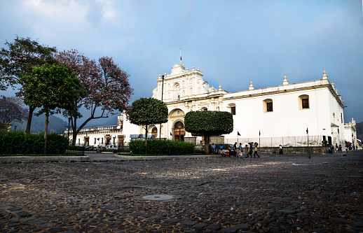 San Jose cathedral on Plaza Mayor square with dramatic blue cloudscape in Antigua, Guatemala