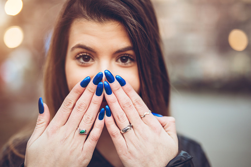 Young beautiful woman posing for camera downtown