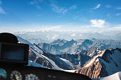 Looking at Mont Blanc massif in french Alps mountains through helicopter cockpit window aerial view