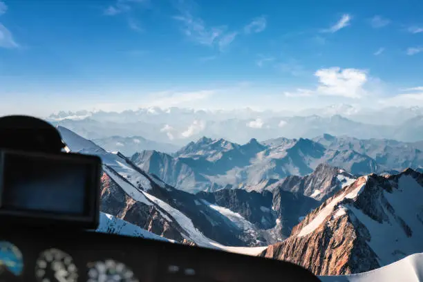 Photo of Looking at Mont Blanc massif in french Alps mountains through helicopter cockpit window aerial view