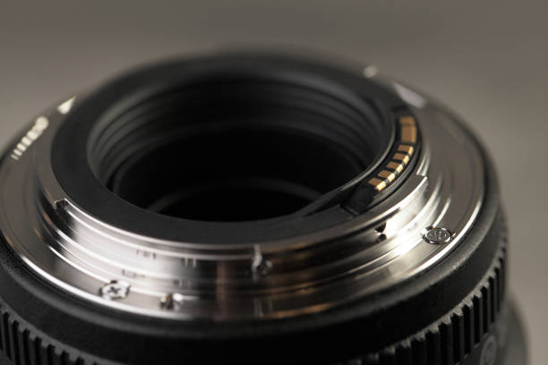 istock Lens for digital SLR cameras on a gray cement background. 1132099798