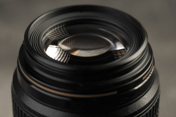 istock Lens for digital SLR cameras on a gray cement background. 1132099800