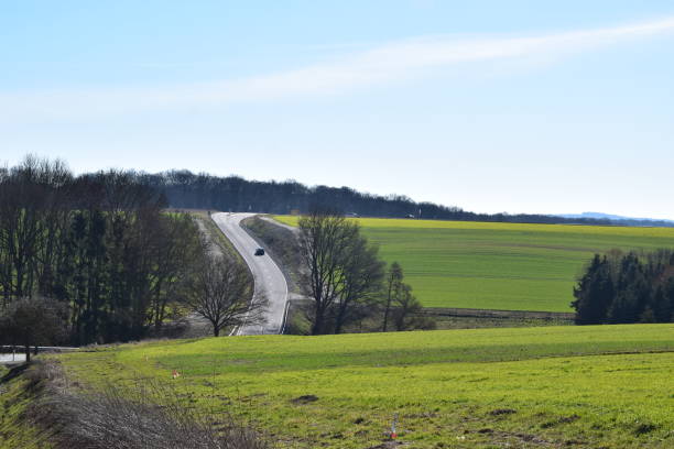 istock twisted country road through green hills 1132100504