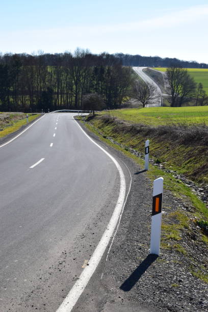 istock twisted country road through green hills 1132100577