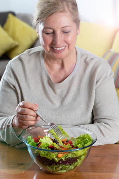 istock Woman dieting and eating a salad 1132100772