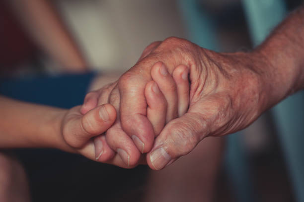istock Holding hand -  grandson and grandfather 1132104758