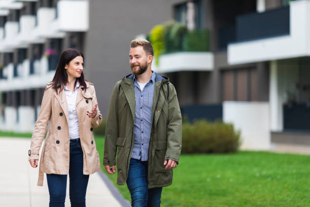 istock Young couple walking in a residential area 1132104768